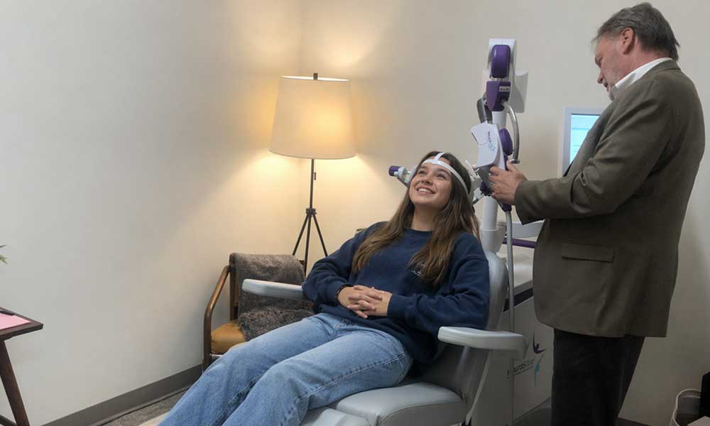 TMS Therapy for teens/adolescents photo of a female teen patient receiving NeuroStar TMS therapy at Sonder in Minnesota.